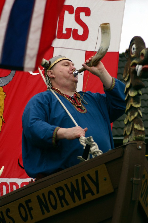 A Viking sounds a horn during a previous Viking Fest Parade in Poulsbo.