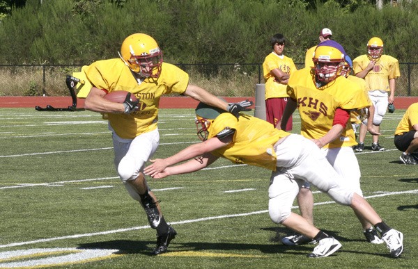 A Kingston High running back does his best impression of John Heisman at practice Tuesday.