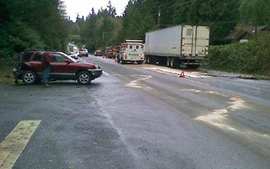 A collision between a semi-truck and SUV Dec. 3 resulted in the closure of State Route 3 near Sunset Way and 100 gallons of spilled diesel fuel over the roadway.