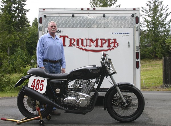 David L. Wells at home in Poulsbo with his 1975 Triumph motorcycle. Wells is the national points leader in an amateur racing circuit