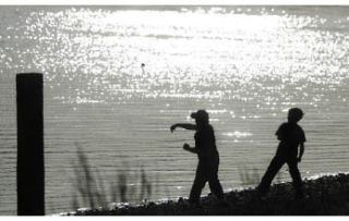 Whitney Logue (left) and Robert Shauger Jr. skip rocks into the water at Lions Park. The park will undergo a $1.7 million renovation starting next spring.