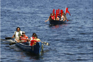 Paddlers approach the Suquamish landing site during the Canoe Journey event in 2007.