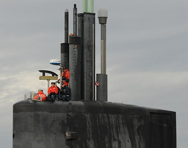 Crew members of the Blue crew of the Ohio-class ballistic missile submarine USS Henry M. Jackson (SSBN 730) man the bridge as the ship pulls into Naval Base Kitsap-Bangor following a strategic deterrent patrol. Jackson is one of eight ballistic missile submarines stationed at the base providing the survivable leg of the strategic deterrence triad for the United States. America's submarine Sailors are warfighters