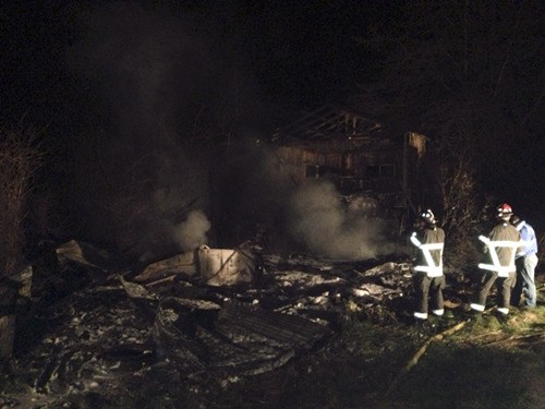 Poulsbo Fire and North Kitsap Fire & Rescue prevent an abandoned house fire from spreading to nearby vegetation Thursday evening.