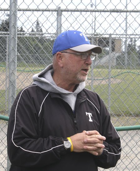 Olympic High School fastpitch coach Dusty Anchors addresses his players Monday in preparation for the Class 2A state tournament.