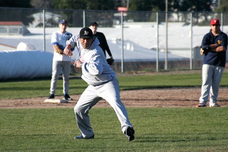 First-year Bremerton High School baseball coach Rob Tomlinson shows a move during practice Friday.