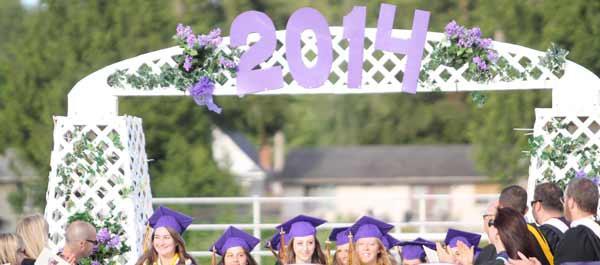 The first of the 2014 North Kitsap High School graduates walk through the gate during the graduation ceremony June 6 at North Kitsap Stadium.