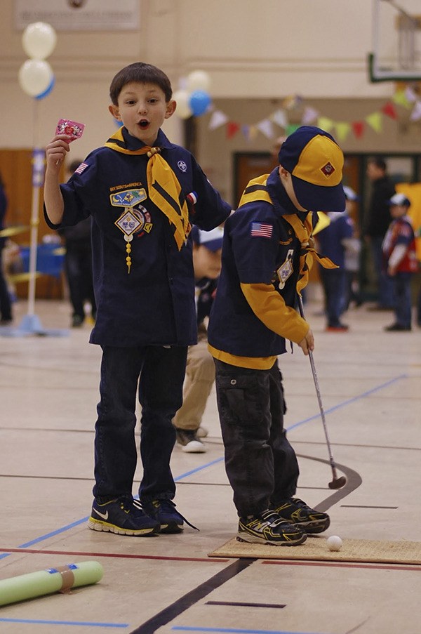 Christopher Meryhew and JP Bray play Putt Putt at the Blue and Gold Carnival-themed Celebration for Cub Scout Pack 4506