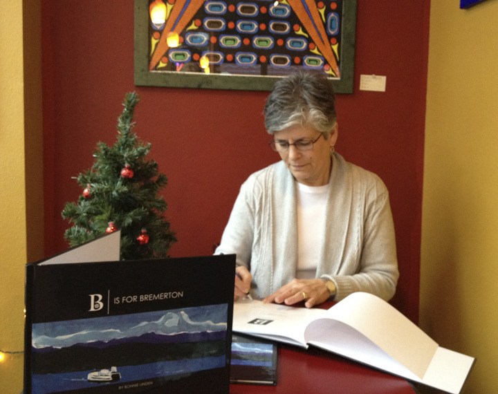 Bonnie Linden signs one of the first copies of “B is for Bremerton” at Cornerstone Coffee.