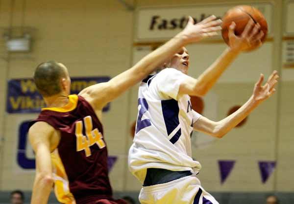 North Kitsap's Michael Urquhart's layup attempt is blocked during the rivalry basketball game Jan. 28 against the Kingston Buccaneers in the North Kitsap High School Gymnasium.