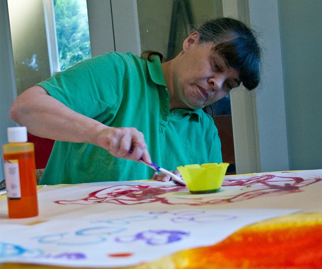 Bainbridge Island Special Needs Foundation client Darien Hellmuth paints during arts and crafts time. BISNF