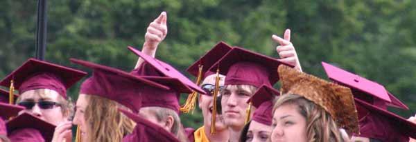 A Kingston High School senior points to family members during the graduation ceremony on Saturday.