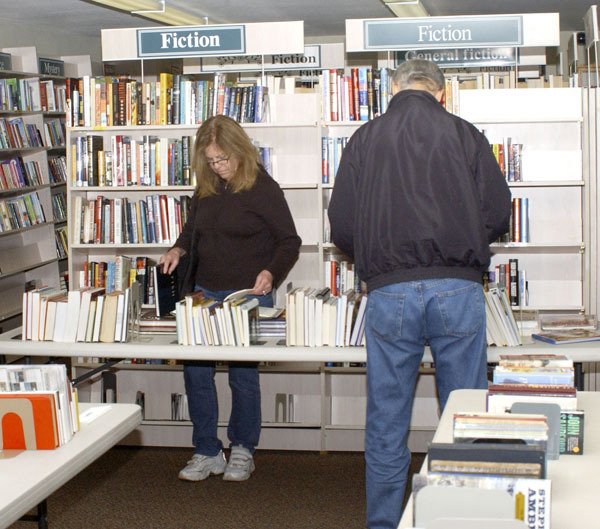 An unidentified woman looks through a table of books during the Feb. 2 Groundhog Day Book Sale sponsored by the Friends of the Manchester Library. The group raised about $825 which goes towards operation and maintenance of the library