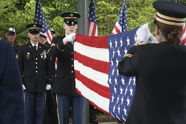 Soldiers fold a flag at Tahoma National Cemetery during part of 'The Unforgotten