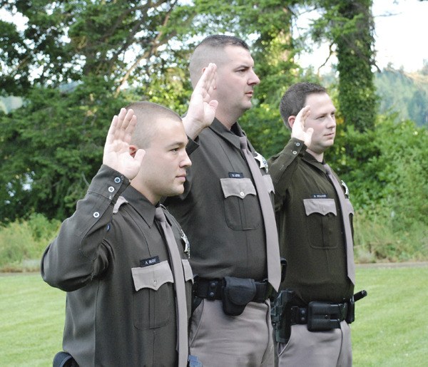 Kitsap County Sheriff Steve Boyer administers the oath of office to newly commissioned Reserve deputy sheriffs