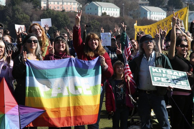 People for peace at last weekend’s event offer the peace sign.