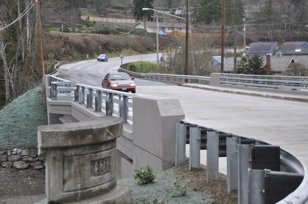 Motorists drive over fresh concrete on the new Curly Creek Bridge.