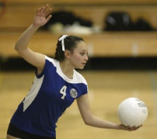 Oly senior libero Cayla Lawson serves against Capital Wednesday. The Lady Trojans were swept 3-0