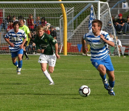 David Gray of the Kitsap Pumas dribbles the ball up the field during a 1-0 loss against the Portland Timbers U23s July 18 at Bremerton Memorial Stadium.