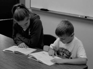 Rolling Reader tutor Ariana Fielding and Suquamish Elementary student Austin West work through “Andrew Wants a Dog.” Fielding reads with four students for a half hour once a week.