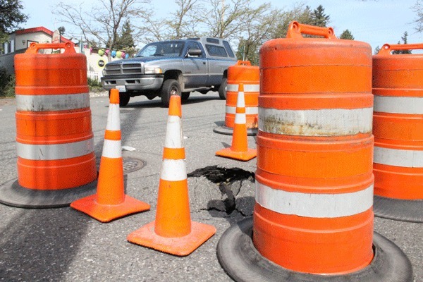 A driver slowed on his way to the Kingston ferry terminal as he passed a sinkhole on Highway 104 May 15. The sinkhole is in the left lane of the highway in downtown Kingston