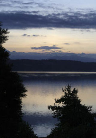 A glimmer of color reflects off the waters of Dyes Inlet near the Tracyton boat launch during a recent sunset.