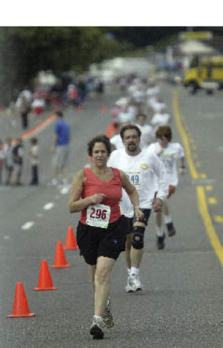 Runners complete the last leg of the 4-Mile Run Saturday.