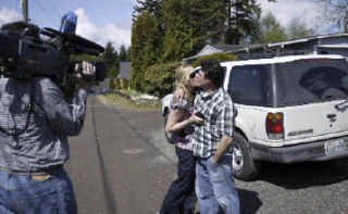 Mike Stevenson kisses his wife Courtnee before she is swept away by the “Evening Magazine” camera crew for her makeover and TV appearance on the “Today Show” on May 9.