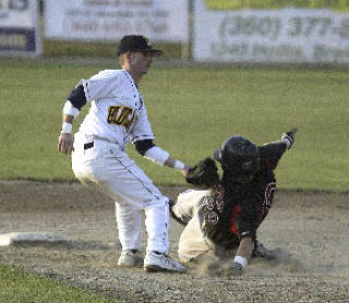 Kitsap shortstop Brandon Decker tags out Moses Lake’s Nick Stiltner