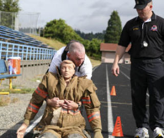 J.D. Willett drags a dummy as part of the agility test for potential Washington Youth Academy employees who will work with at-risk youth to help redirect their lives.