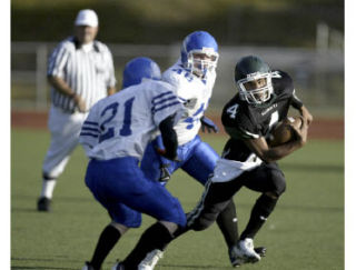 Klahowya’s Andre Moore darts around a North Mason defender during its Sept. 26 loss. The Eagles fell 32-14 despite nearly 150 rushing yards from Moore.