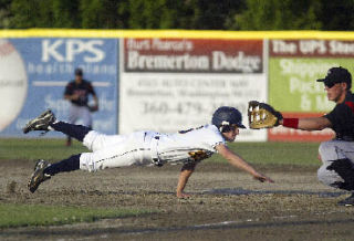 Kitsap Bluejackets #16 Doug Buser dives back to first base in a attempted pick off play.  Buser stole second on the next pitch against Moses Lake on Tuesday.