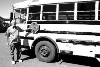 NKSD Director of Transportation Ron Lee points out a buses’ most important loading and unloading safety feature: the stop sign arm. Learning about everything bus safety is a major component of bus driver training.