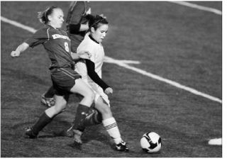 Kingston High School middle Dana Van Wyck battles for the ball against North Kitsap middle Elya Le during action at North Kitsap Thursday.