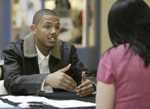 Central Kitsap High School sophomore Christian Wesley explained his sports project to Mckenzie Kelly of Safeway during the DECA Area 7 competition at Kitsap Mall on Wednesday.