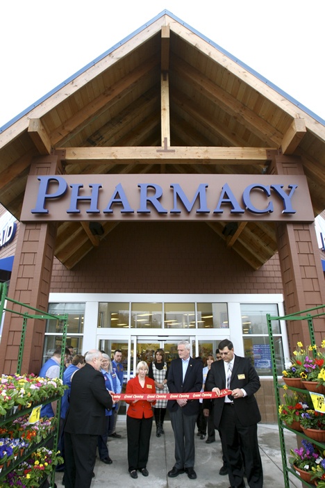 Rite Aid managers and Kitsap County Commissioner Steve Bauer (second from right) join in the ribbon cutting for the new store.