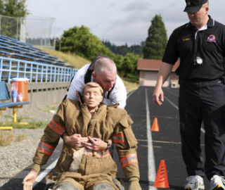 J.D. Willett drags a dummy as part of the agility test in August for potential Washington Youth Academy employees who will work with at-risk youth to help redirect their lives. The academy