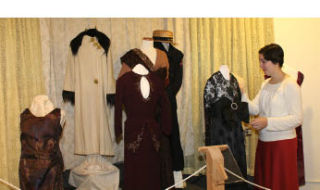 Kitsap County Historical Society Museum Curator Erin O’Brien fluffs up a dress belonging to a Bainbridge Island woman who collects dresses. The display is one of several collections at the museum as part of the “What Kitsap Collects: A Unique Perspective” exhibit.