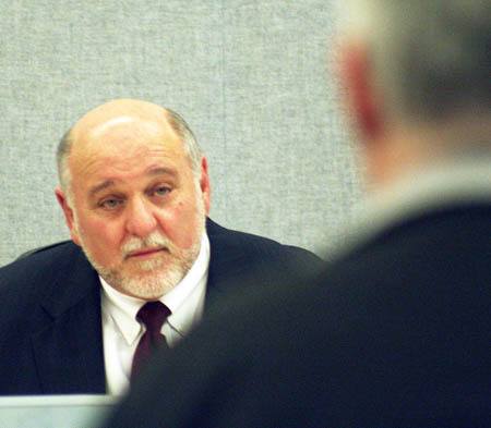 Port Orchard Mayor Lary Coppola responds to a question during the public comment period of the May 11 city council meeting — his first since being arrested for driving under the influence 10 days earlier.