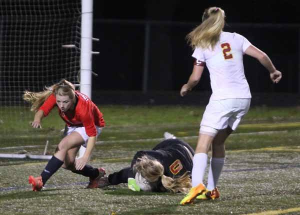 Kingston junior goalie Emma Keeling traps the soccer ball during the State playoff game against Archbishop Murphy Nov 13.