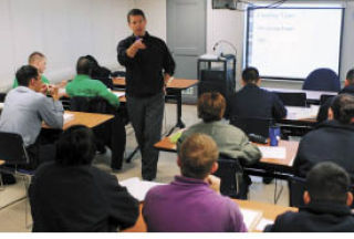 John C. Stennis University instructor Chad Stober teaches students to speak Japanese in a classroom on board USS John C.Stennis (CVN 74).