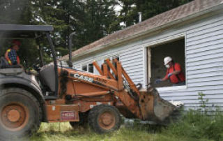 Hos Brothers Construction deconstructs houses in Westpark this week. The Bremerton Housing Authority-owned property is being torn down to build the new mixed-use community