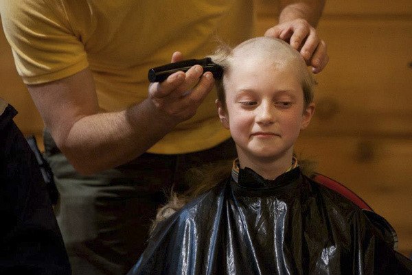 Suquamish Elementary School third-grader Faro Morris donates his hair for Locks of Love April 13 during Carmen’s Prom.