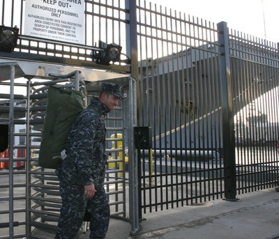 A sailor disembarks the USS Ronald Reagan Tuesday afternoon following the aircraft carrier’s arrival at Puget Sound Naval Shipyard for scheduled year-long maintenance.