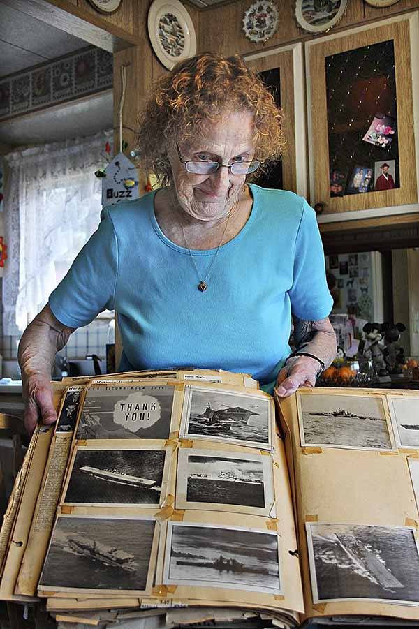 Berniece Blees looks at a scrapbook of her days at the shipyard.