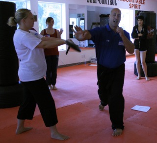 Self defense safety instructors Lindsey Cornwell and Todd Norcross demonstrate the palm heel strike.