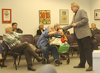 Port Orchard Mayor Tim Matthes hands the microphone to resident Jerry Harmon during the March 14 Town Hall meeting.