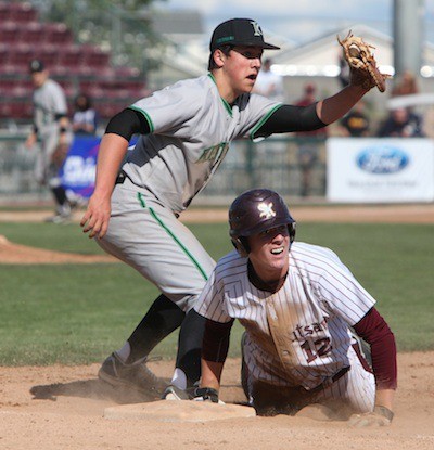 South Kitsap's Tom Simpson looks at the umpire after he slid back to first as the Kentwood first baseman looks for a call.