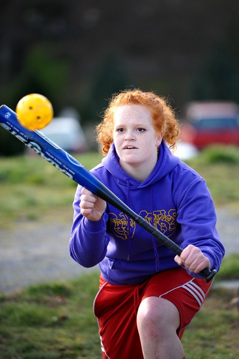 North Kitsap High softball player Sydney Thompson practices her bunting technique.