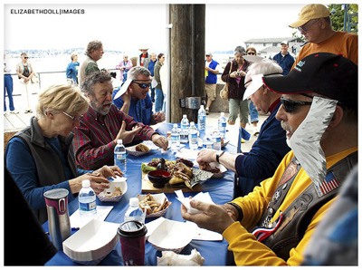 A group of judges taste wings and make notes during the wings cook-off last year.